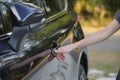 Closeup of driver hand opening car front door with touch ID finger imprint scanning technology. Vehicle safety concept Royalty Free Stock Photo