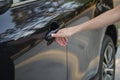 Closeup of driver hand opening car front door with touch ID finger imprint scanning technology. Vehicle safety concept Royalty Free Stock Photo