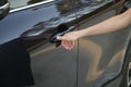 Closeup of driver hand opening car front door with touch ID finger imprint scanning technology. Vehicle safety concept Royalty Free Stock Photo