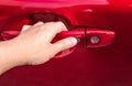 Hand holding and pushing lock and unlock button at car door handle Royalty Free Stock Photo