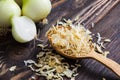 Closeup dry onion flakes in wooden spoon