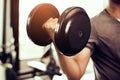 Closeup of dumbbell. young man lifting heavy weights. Sport equipment and workout concept. Body builder and Strength concept. Royalty Free Stock Photo
