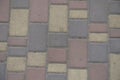 Closeup of dusty brown, yellow and pink colored concrete pavers