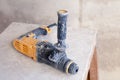 Closeup dusty building tool drill on the wooden scaffolding. Concept background construction site and renovation in kitchen of