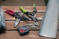 Closeup dusty construction building tools on the scaffolding, puncher, drill, perforator, in the box, cutter, cutter on