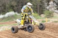 Closeup dynamic shot of quad rider in yellow Royalty Free Stock Photo