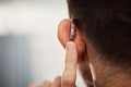 Closeup of ear, hearing aid and man with disability from the back for support, improve listening or amplifier with Royalty Free Stock Photo