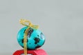 Closeup Easter blue egg on red car. Holiday easter concept. Royalty Free Stock Photo