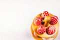 Closeup Easter red eggs with folk white pattern lay around on stand for eggs which stand in down side on white background. Ukraini