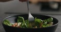 Closeup eating fresh salad with mozzarella and cherry tomatoes with fork