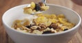 Closeup eating with a spoon breakfast with corn flakes and mix of nuts and fruits Royalty Free Stock Photo