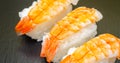 Closeup of ebi king prawn nigiri prepared by a Japanese chef in a restaurant Royalty Free Stock Photo