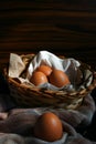 Egg up close. Egg basket on fabric. Wooden background