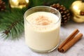 closeup of eggnog in a glass mug with a cinnamon sprinkle