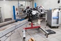 Closeup of a eight cylinder auto engine on a special red stand in a car workshop. Disassembled part during repair in service