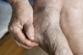 Closeup of elderly hand massaging foot