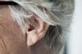 Closeup of elderly retirement woman`s ear