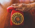 Woman hand on red old fashioned style telephone Royalty Free Stock Photo