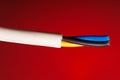 closeup of a electric cable on a red background. Royalty Free Stock Photo