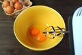 Electric Egg Beater Going to Beat aPair of Raw Eggs in Mixing Bowl Royalty Free Stock Photo