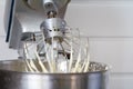 Closeup of electric mixer with whipped smooth dough for cake. Batter being whipped. Mixing white dough in bowl with motor mixer Royalty Free Stock Photo