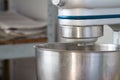 Closeup of electric mixer with whipped smooth dough for cake. Batter being whipped. Mixing white dough in bowl with motor mixer Royalty Free Stock Photo