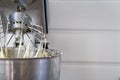 Closeup of electric mixer with whipped smooth dough for cake. Batter being whipped. Mixing white dough in bowl with motor mixer Royalty Free Stock Photo