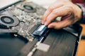 Closeup of electrical engineer technician changing memory in laptop computer