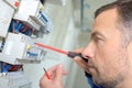 Closeup electrician working on fusebox