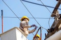 Electricians working on cable car to repair the power line
