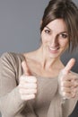 Closeup of elegant beautiful young woman laughing with thumbs up Royalty Free Stock Photo