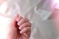 Closeup elegant pastel natural modern design manicure on fabric silk background. Female hands. Gel nails. Nude manicure. Beige Royalty Free Stock Photo