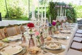 Closeup of elegant table setting with colorful flowers for the outdoor wedding party Royalty Free Stock Photo