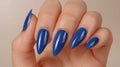 Closeup of elegant woman s hand showcasing stylish blue nail polish for a glamorous look