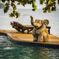 Closeup elephant statue spraying water in a swimming pool next to the sea , Thailand Royalty Free Stock Photo