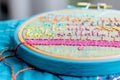 closeup of embroidered quote on fabric in brightcolored hoop Royalty Free Stock Photo