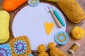 Closeup of embroidery hoop with fabric surrounded with craft instruments, tools skeins of yarn, crochet hook, punch needle Royalty Free Stock Photo