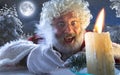 Close-up portrait of emotional Santa Claus writing a letter,wish list with New Year and Christmas in midnight with Royalty Free Stock Photo