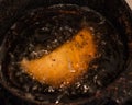 Closeup of empanada deep fried in a pot Royalty Free Stock Photo