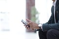 Closeup. employee typing SMS on the smartphone