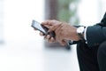 Closeup. employee typing SMS on the smartphone