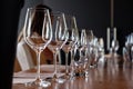 Closeup Empty Clear Transparent Crystal Wine And Water Glasses Standing On Table In Straight Rows On Wine Tasting. Concept Modern