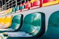 Closeup of Empty Colorful Football & x28;Soccer& x29; Stadium Seats in the Winter Covered in Snow - Sunny Winter Day