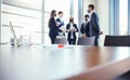 Closeup of an empty conference room before meeting with blurred people in protective on the background Royalty Free Stock Photo