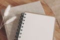 Closeup of empty diary, notepad mockup and book on wooden table. Dry Lagurus ovatus grass, blurred background. Top view Royalty Free Stock Photo