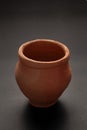 Closeup of Empty Indian Hand Made Clay Red Pot kulhad unglazed, over black Background