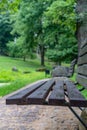 Closeup of Empty Park Benches in Sunny Summer Day With Golden Leaves in Trees, Latvia, Europe, Concept of Sadness and Loneliness Royalty Free Stock Photo