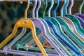 closeup of empty plastic hangers in various colors on a rail Royalty Free Stock Photo