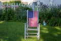 Rustic old wood rocking chair sitting in yard with USA flag on b Royalty Free Stock Photo