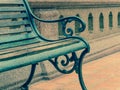 Closeup empty vintage bench in front of rugged wall Royalty Free Stock Photo